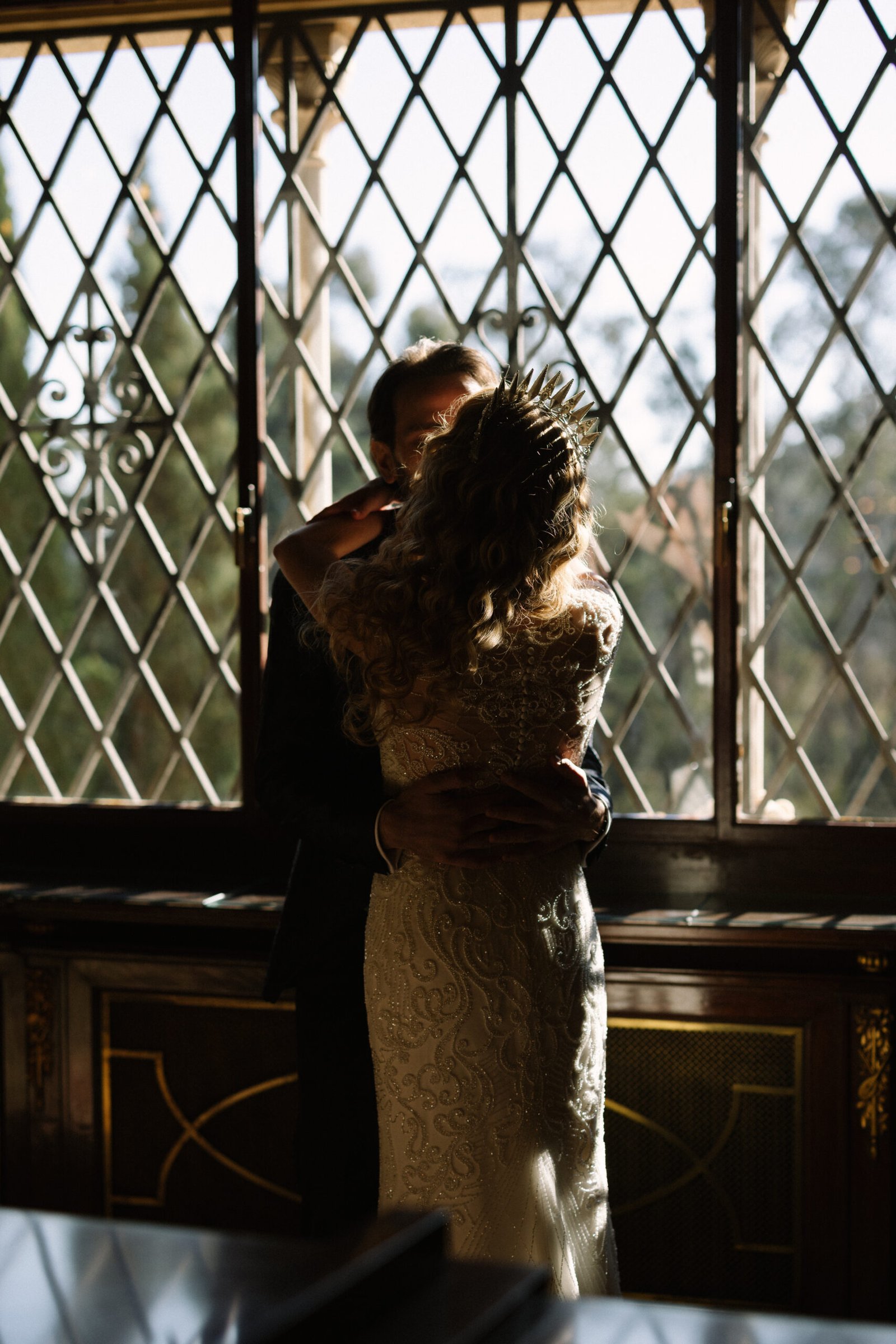 Elegantly dressed couple embracing on their destination wedding day in Barcelona, celebrating a romantic moment in a sophisticated setting.